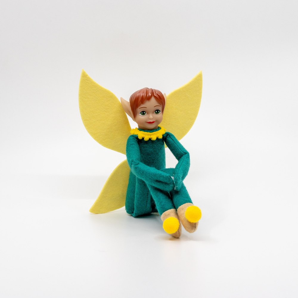 Felt Tooth Pixie figurine with yellow wings and shoes on a white background