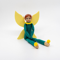 Tooth Pixie figurine with yellow wings and feet on a white background