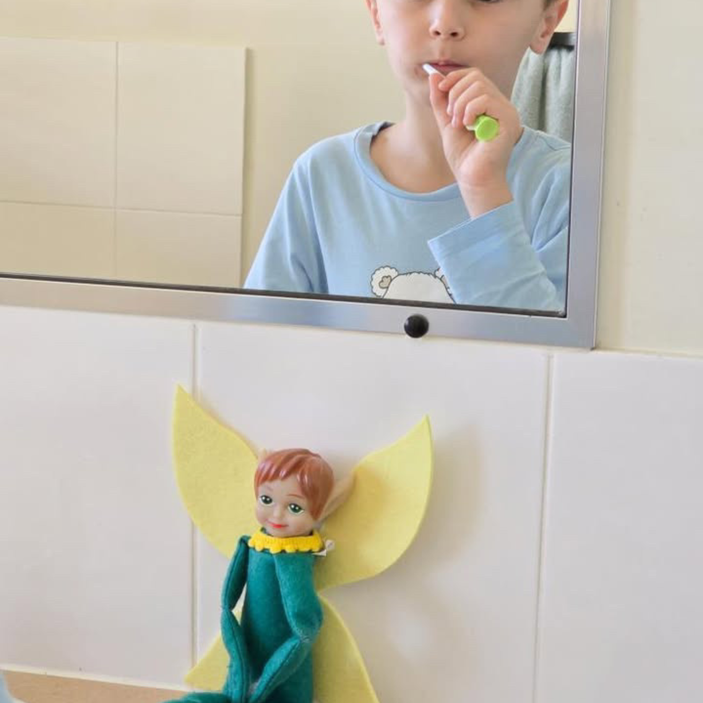 Child brushing teeth in front of a mirror with a Tooth Pixie watching on