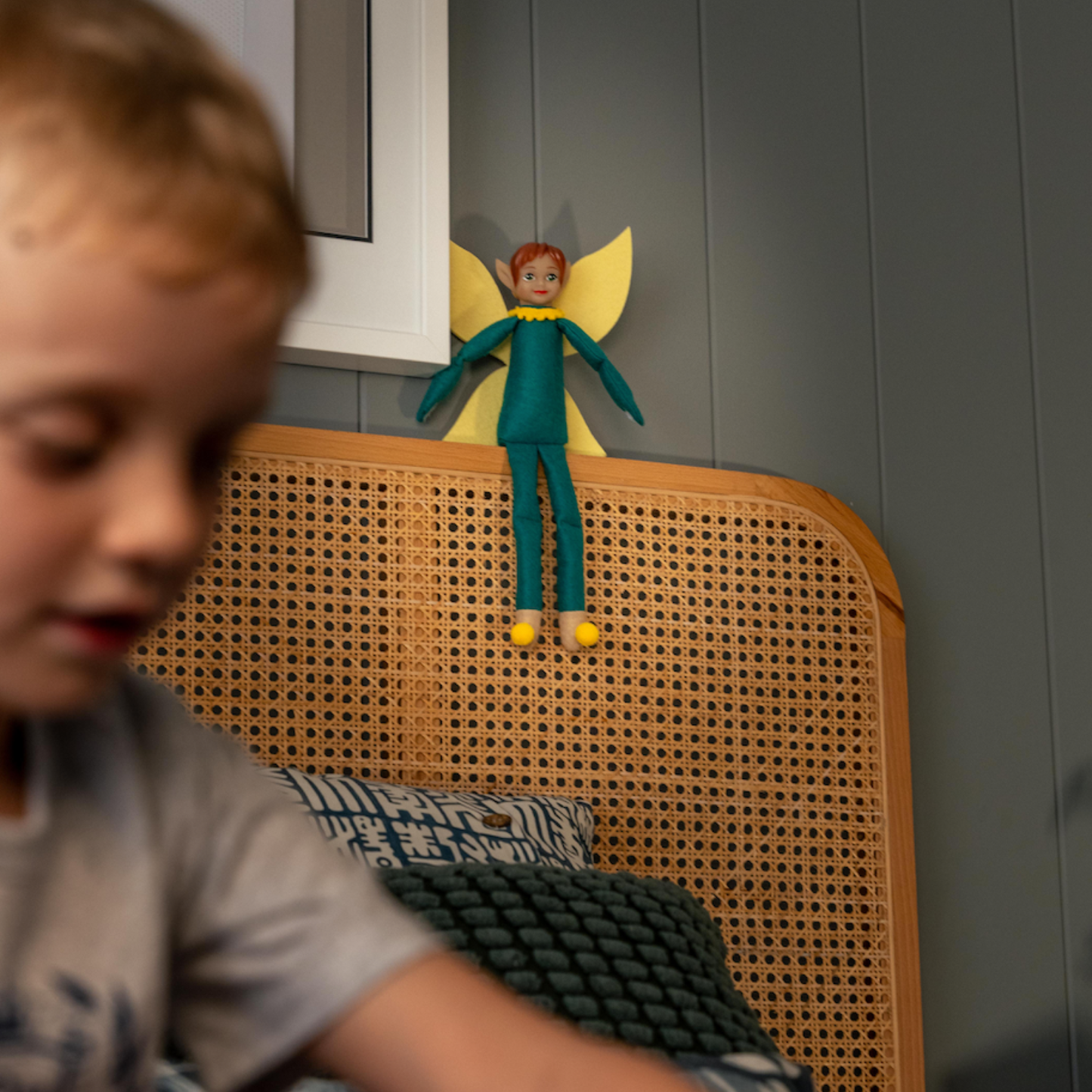 Child playing with Tooth Pixie watching on