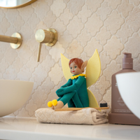 Tooth Pixie on a bathroom counter watching for tooth brushing activities