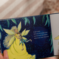 Illustration of Tooth Fairy Mother holding a Tooth Pixie in a book with a starry night background